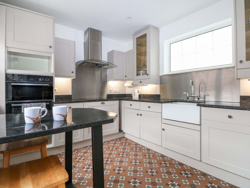 A kitchen with a sink and oven at 19 Queen Street in Emsworth