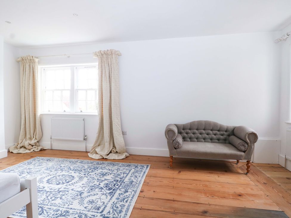 A living room with a sofa and a rug at 19 Queen Street in Emsworth