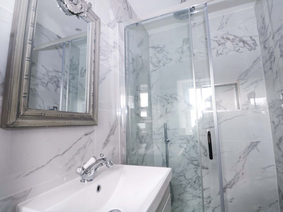 A bathroom featuring a shower and sink at 19 Queen Street, Emsworth