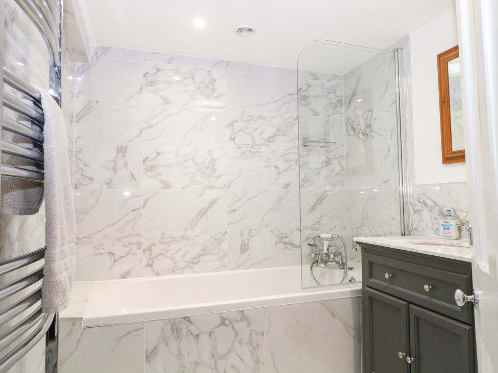 A bathroom with a bathtub and shower at 19 Queen Street in Emsworth
