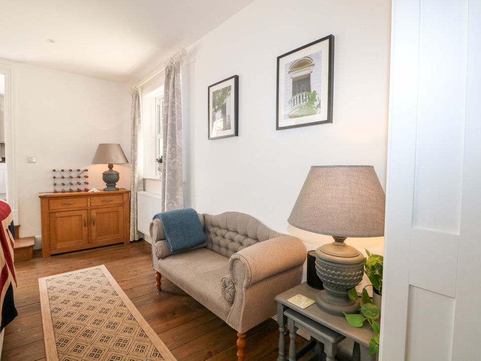 A living room with a couch and lamp at 19 Queen Street in Emsworth