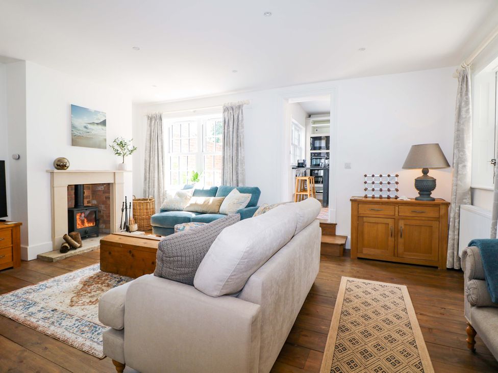 A living room with a fireplace and sofa at 19 Queen Street Emsworth