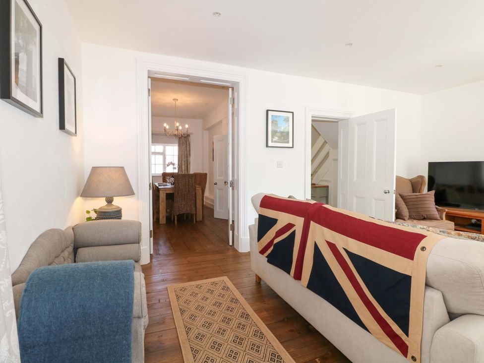 A living room with a sofa and a dining area at 19 Queen Street in Emsworth