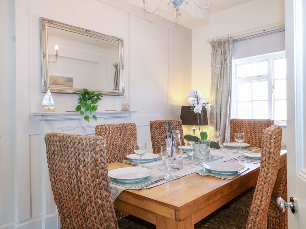 A dining room with a table set for dinner at 19 Queen Street Emsworth