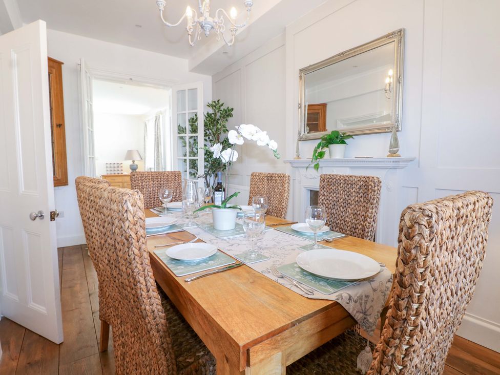 A dining room with a table set for dinner at 19 Queen Street Emsworth