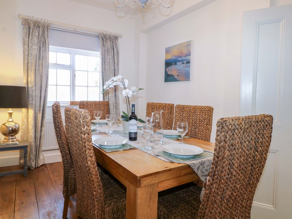 A dining room with a table set for dinner at 19 Queen Street Emsworth