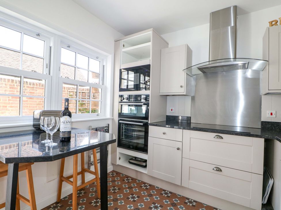A kitchen with cabinets and appliances at 19 Queen Street in Emsworth