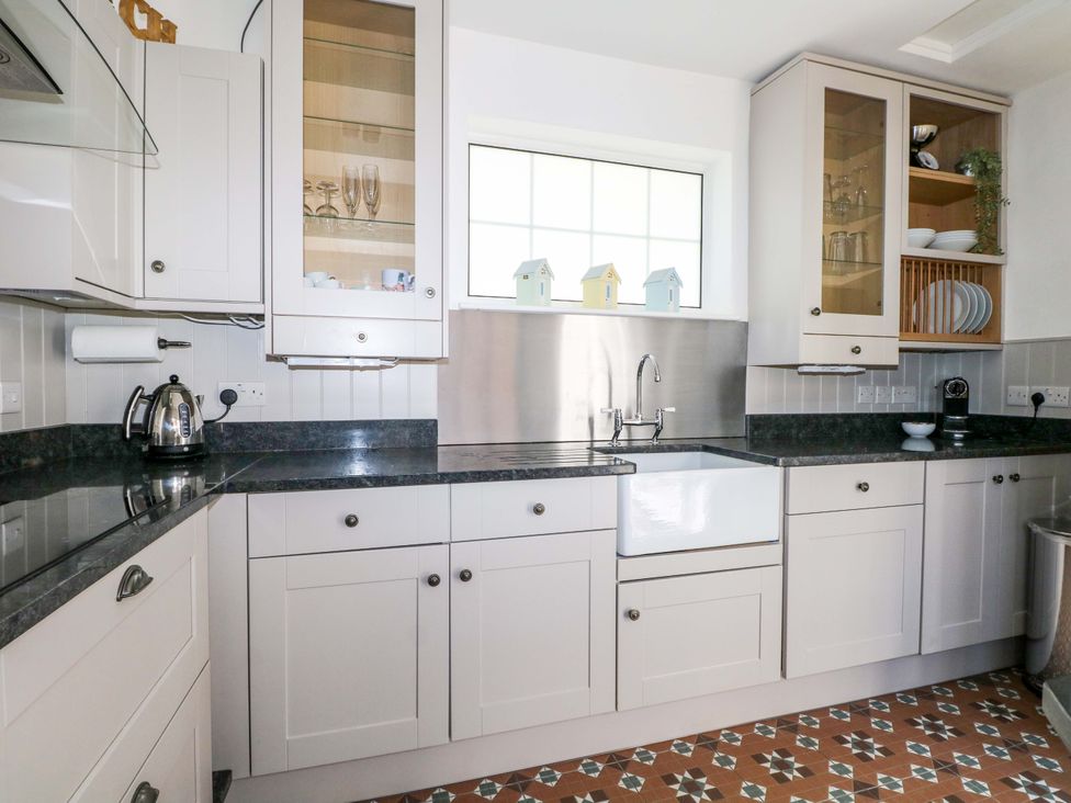 A kitchen with a sink and cabinets at 19 Queen Street in Emsworth