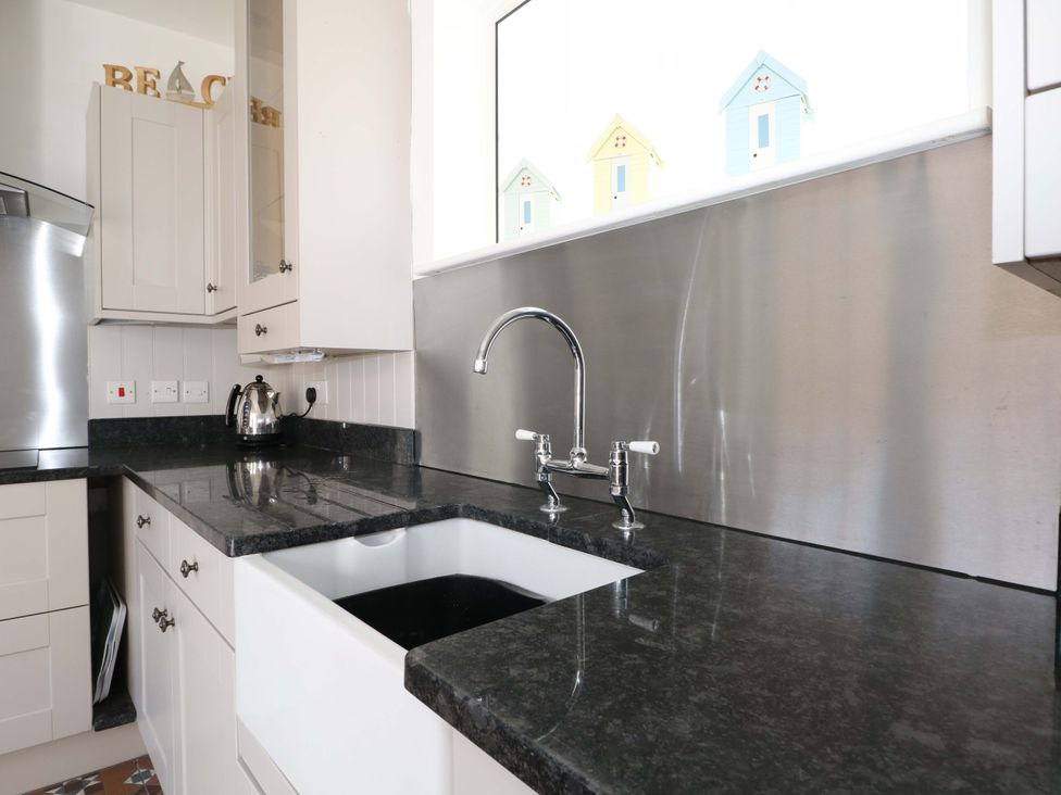 A kitchen with a sink and kettle at 19 Queen Street Emsworth