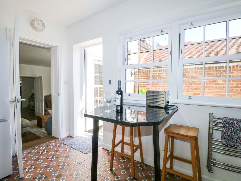 A kitchen with a table and chairs at 19 Queen Street in Emsworth