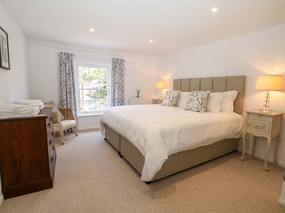 A bedroom with a bed and nightstands at 19 Queen Street in Emsworth