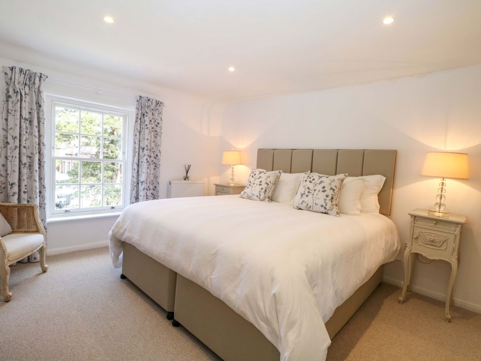 A bedroom with a bed and bedside tables at 19 Queen Street in Emsworth
