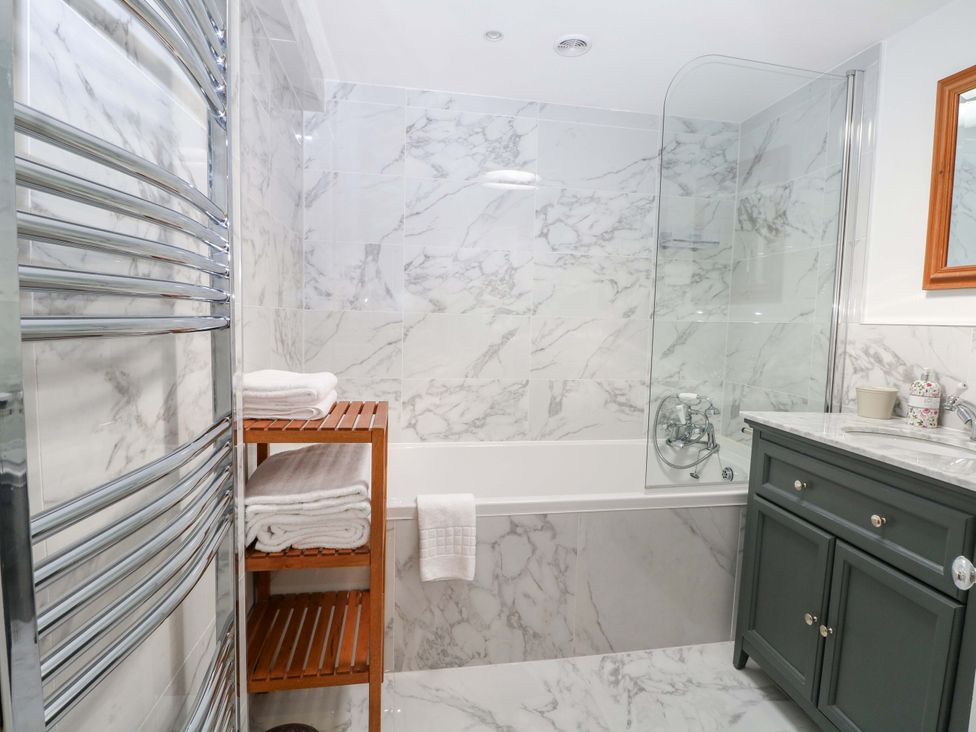 A bathroom featuring a bathtub and a towel radiator at 19 Queen Street Emsworth