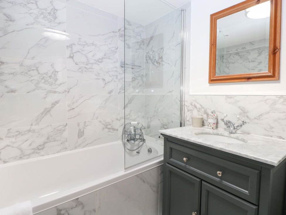A bathroom with a bathtub and sink at 19 Queen Street in Emsworth