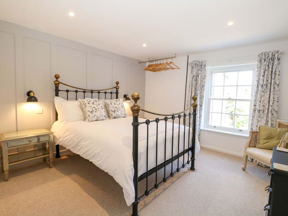 A bedroom with a bed and bedside table at 19 Queen Street Emsworth