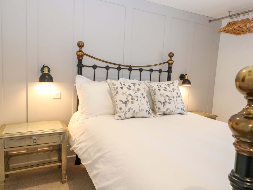 A bedroom with a bed and bedside tables at 19 Queen Street in Emsworth