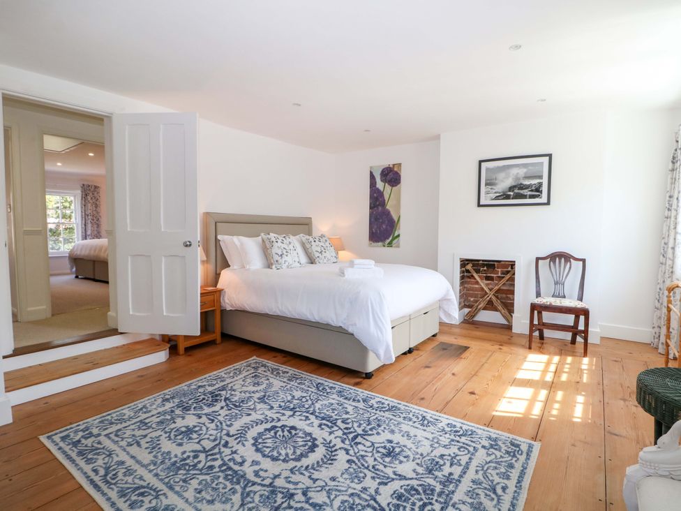 A bedroom with a bed and a chair at 19 Queen Street Emsworth