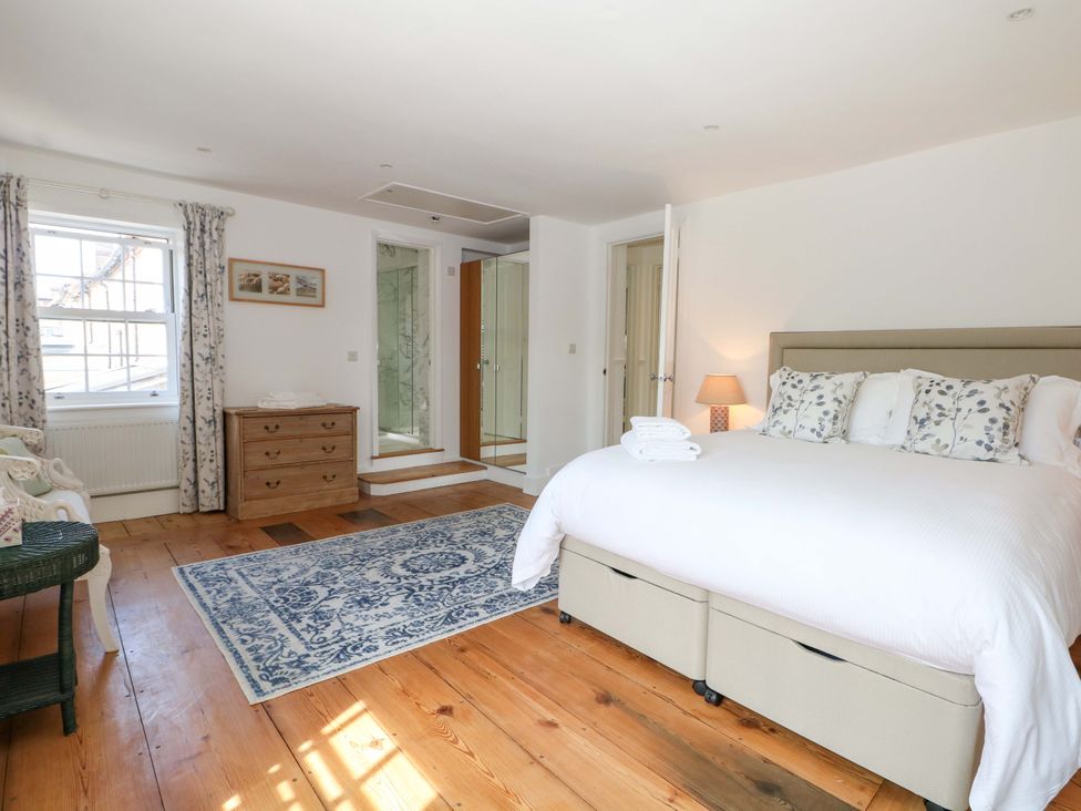 A bedroom with a bed and dresser at 19 Queen Street in Emsworth