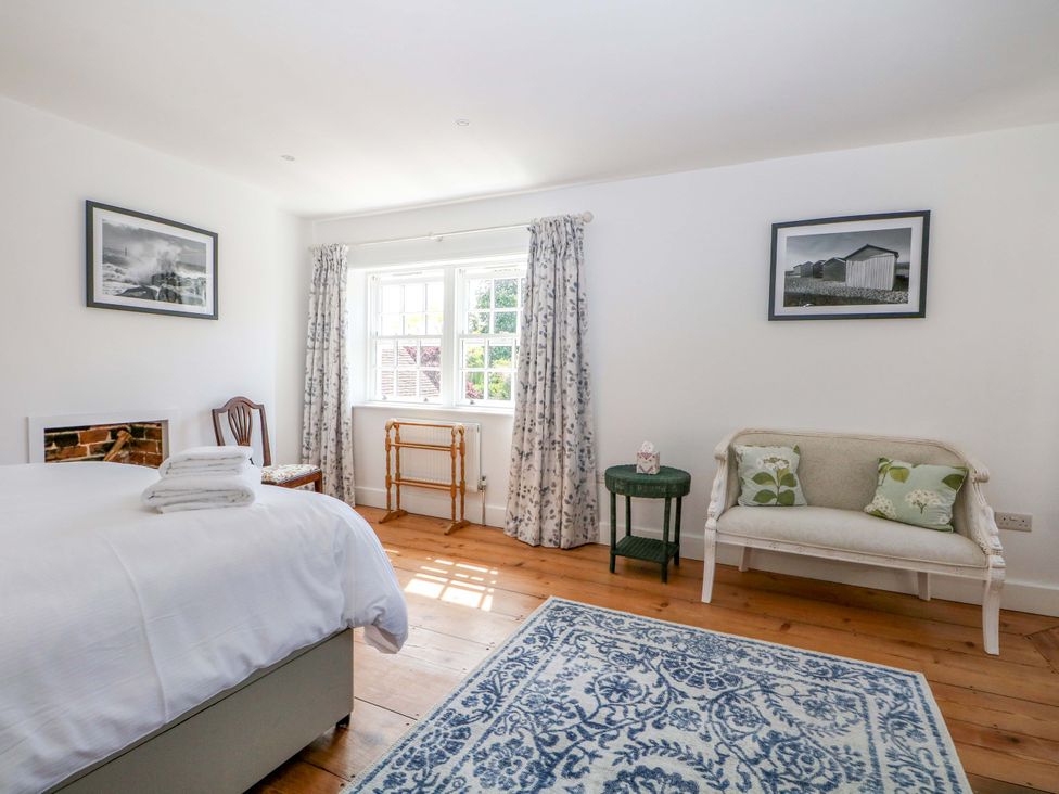 A bedroom with a bed and sofa at 19 Queen Street Emsworth