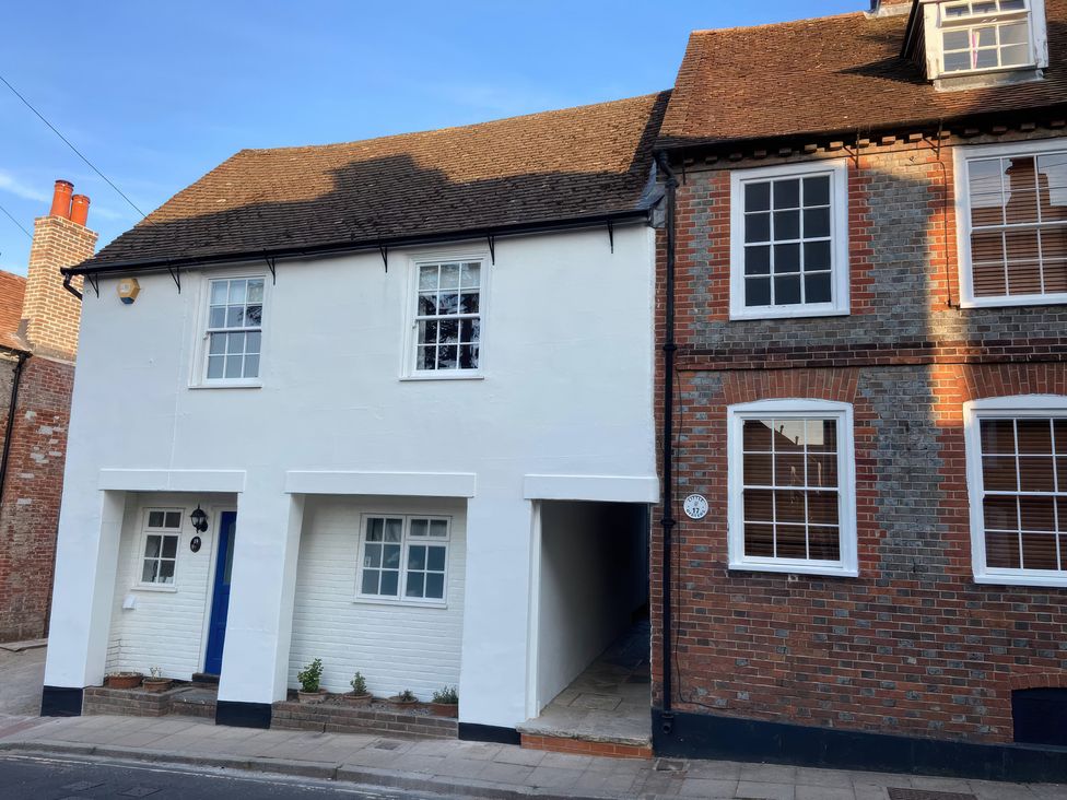 A building with a white exterior and brick wall at 19 Queen Street Emsworth