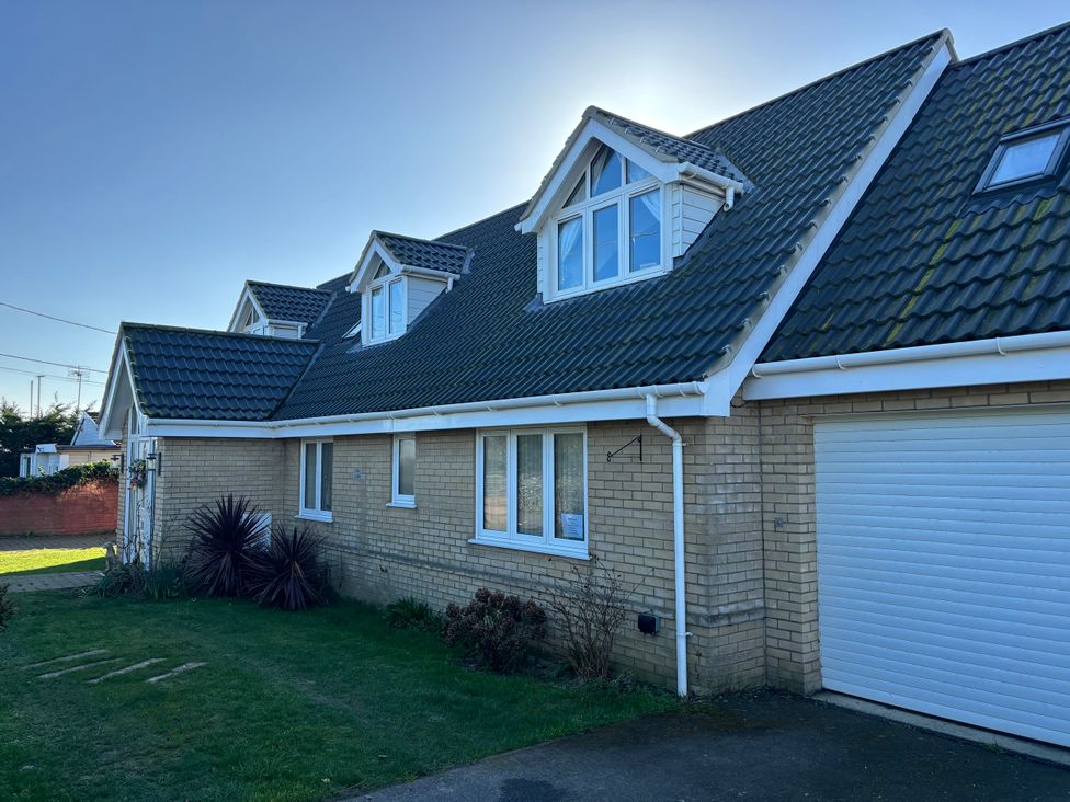 A house with a garage and windows at Seaview in Pakefield