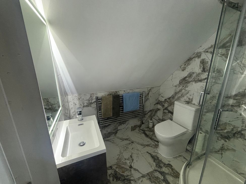 A bathroom with a sink, toilet, and shower at Seaview in Pakefield