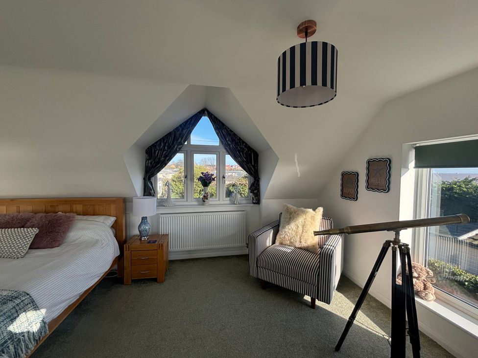 A bedroom with a bed and telescope at Seaview in Pakefield