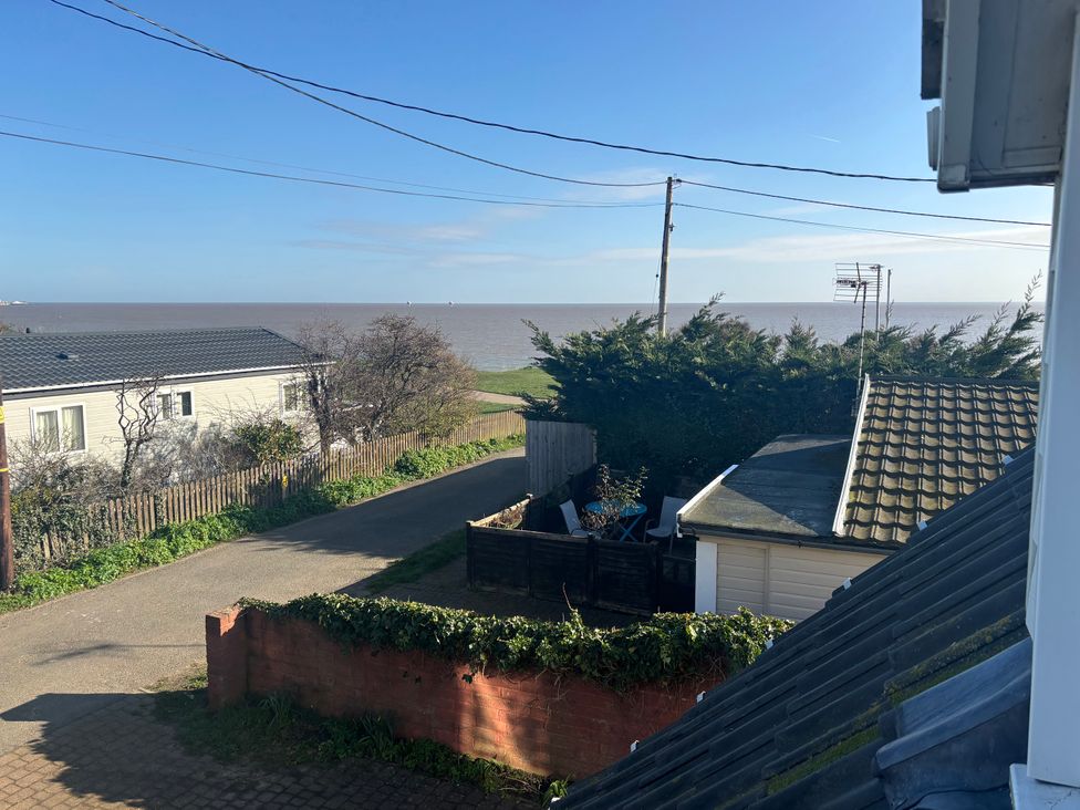 A view of the sea and houses from an outdoor area at Seaview in Pakefield