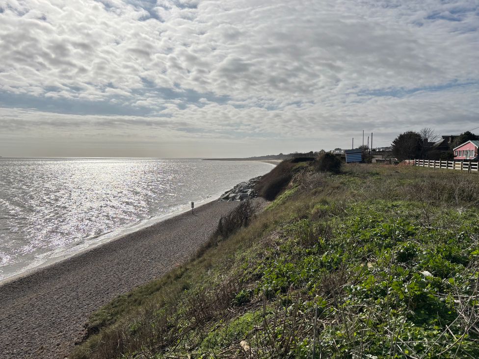 A beach with rocks and grass at Seaview in Pakefield