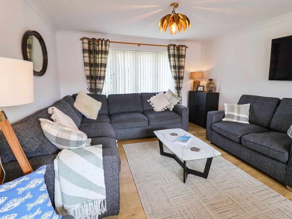 A living room with a sofa and coffee table at Seaview in Pakefield