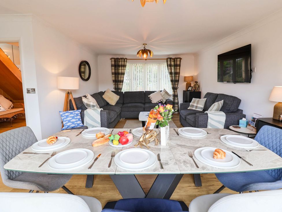 A dining room with a table set for meals at Seaview in Pakefield