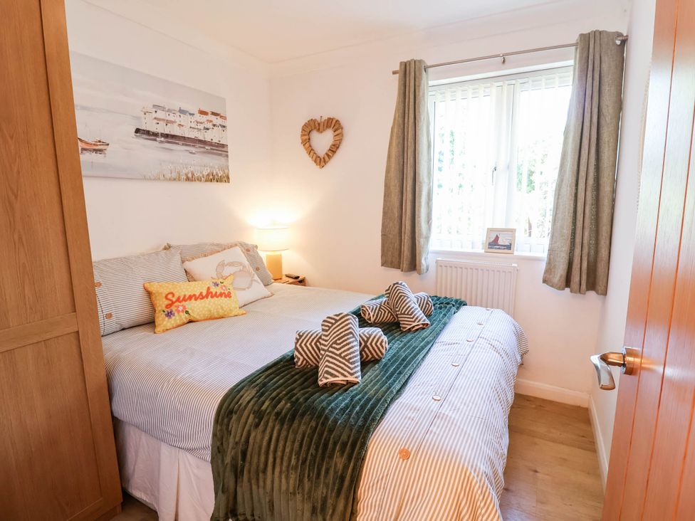 A bedroom with a bed and wardrobe at Seaview in Pakefield