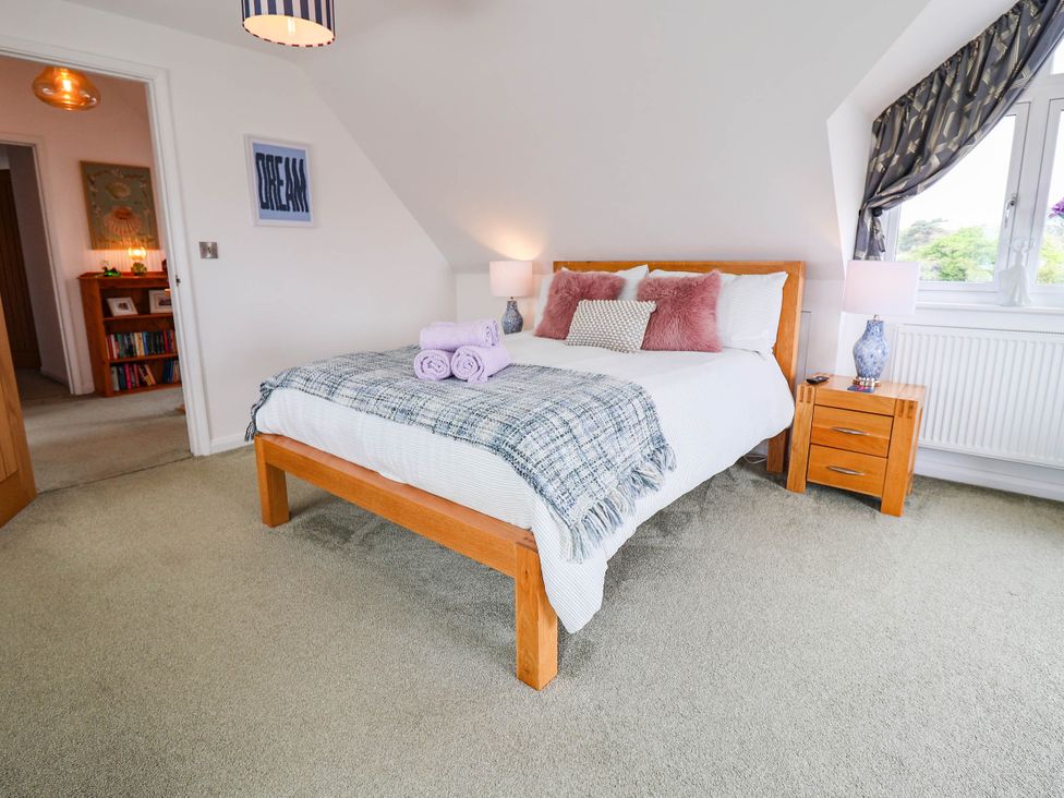 A bedroom with a bed and bedside table at Seaview in Pakefield