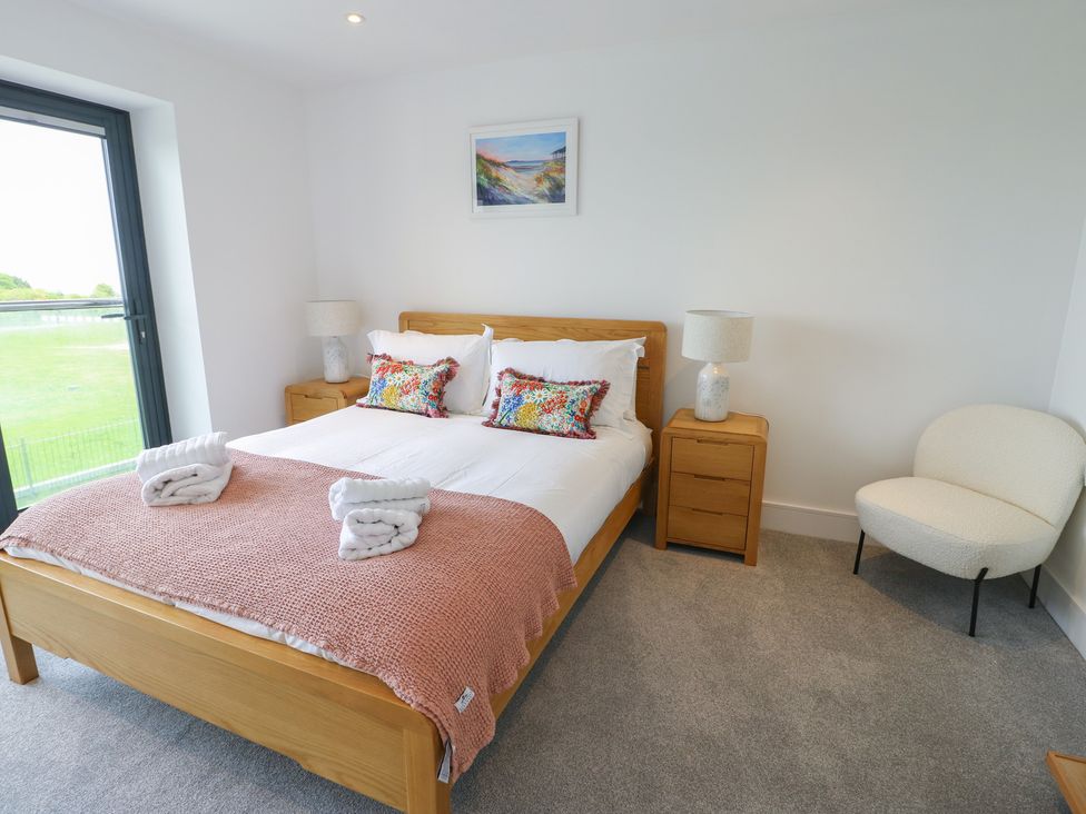 A bedroom with a double bed and nightstands at Glynllifon 5 Marian-glas near Benllech