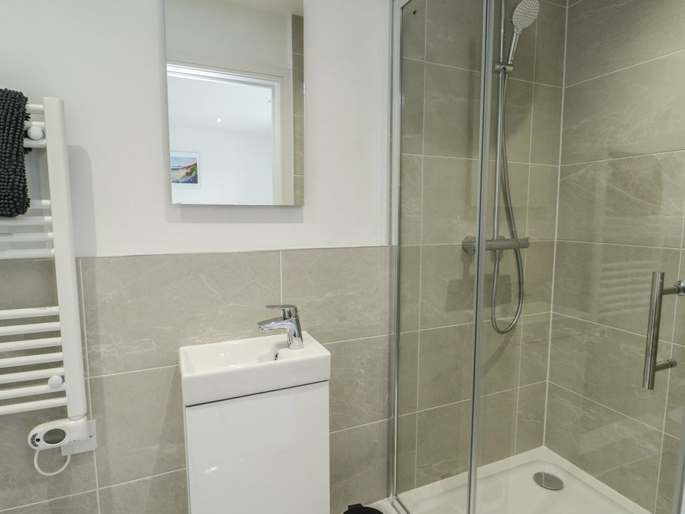 A bathroom with a shower and sink at Glynllifon 5 in Marian-glas near Benllech