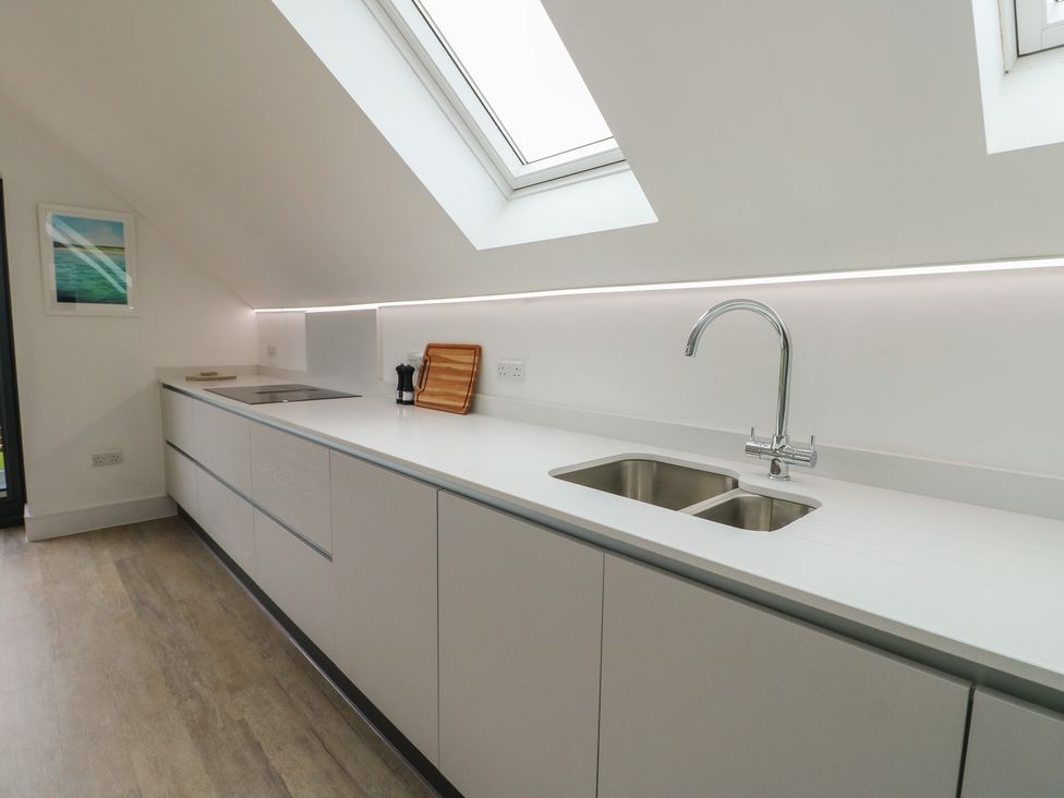 A kitchen with a sink and countertop at Glynllifon 7 Marian-glas near Benllech