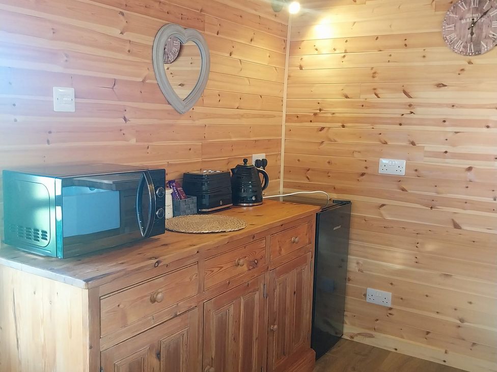 A kitchen with a microwave, kettle, and coffee maker at The Damselfly Bewholme near Hornsea