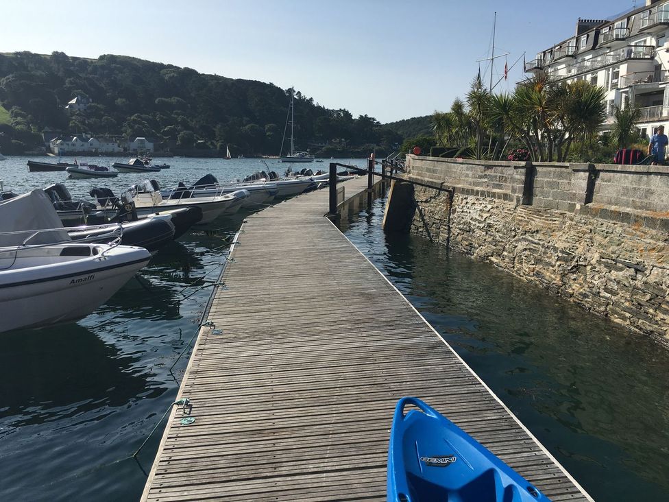 A dock with boats alongside water at 24 The Salcombe in Salcombe