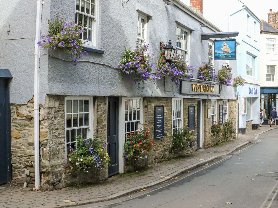 A building with flower boxes and a sign in Salcombe