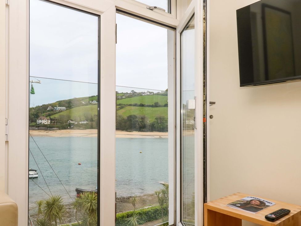 A living room with a view of the water at 24 The Salcombe in Salcombe