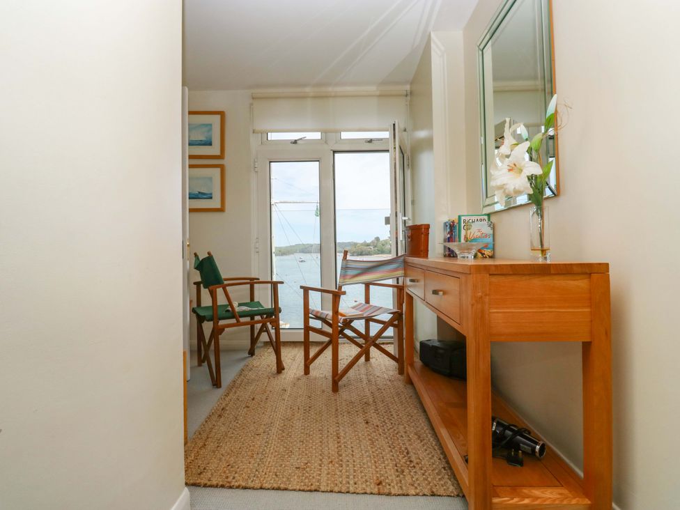A hallway with a table and chairs at 24 The Salcombe in Salcombe