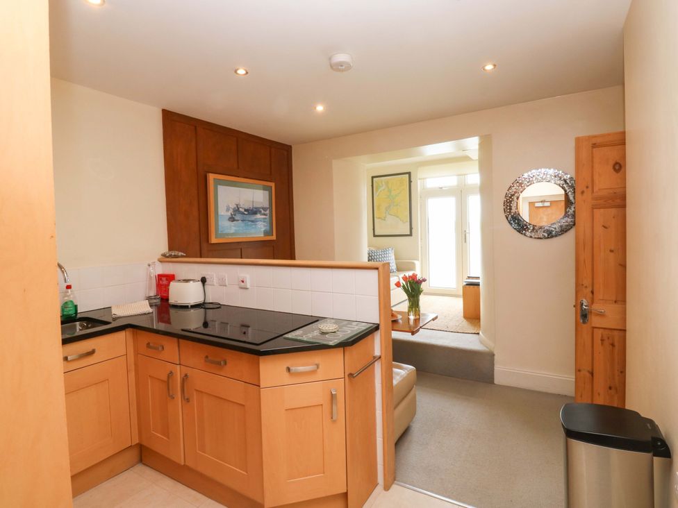 A kitchen with countertops and cabinets at 24 The Salcombe in Salcombe