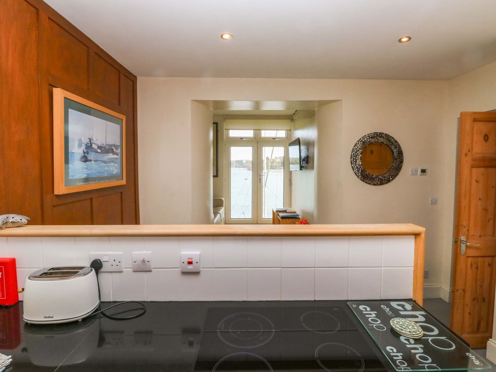 A kitchen with a toaster and cooker at 24 The Salcombe in Salcombe