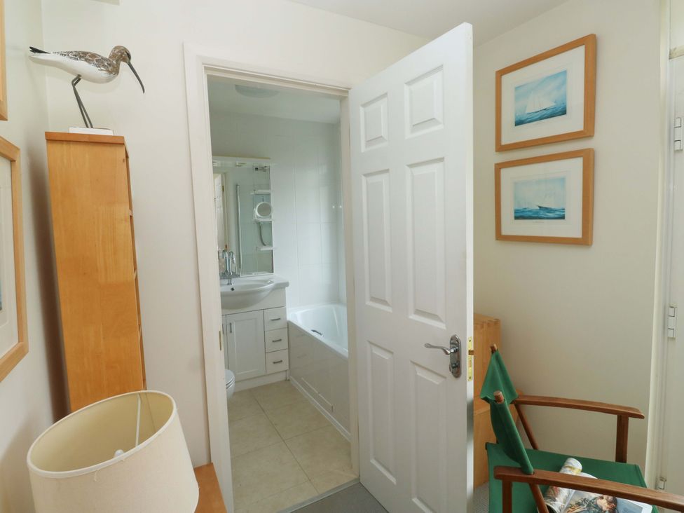 A bathroom with a sink and bathtub at 24 The Salcombe in Salcombe