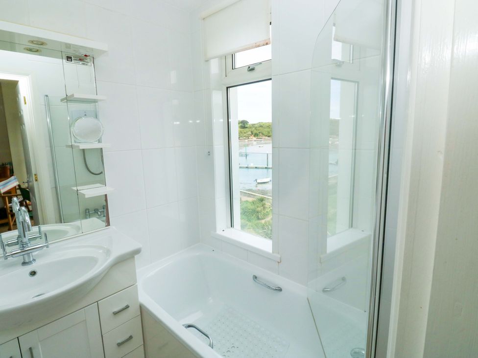 A bathroom with a bathtub and sink at 24 The Salcombe in Salcombe