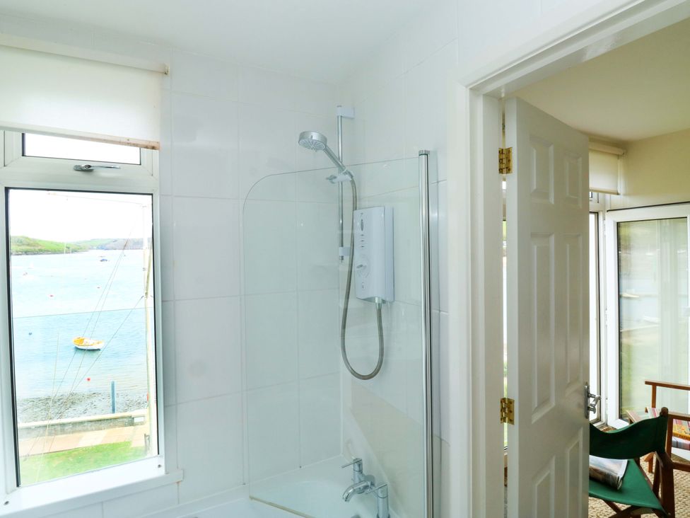 A bathroom with a shower and window at 24 The Salcombe in Salcombe