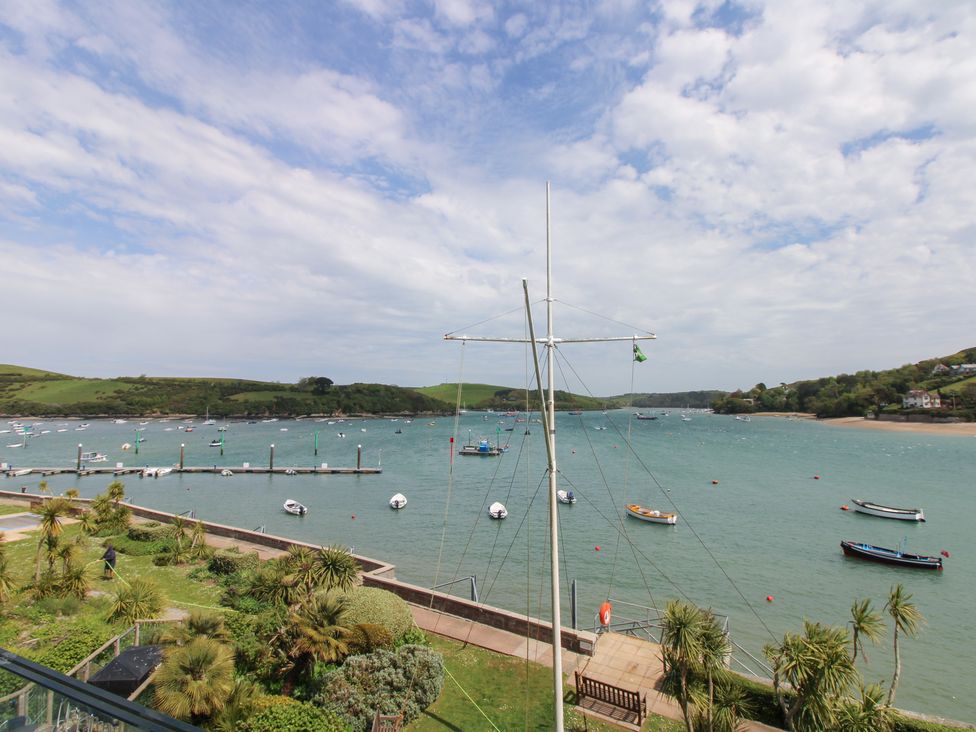 A view of a bay with boats and a pier at 24 The Salcombe in Salcombe