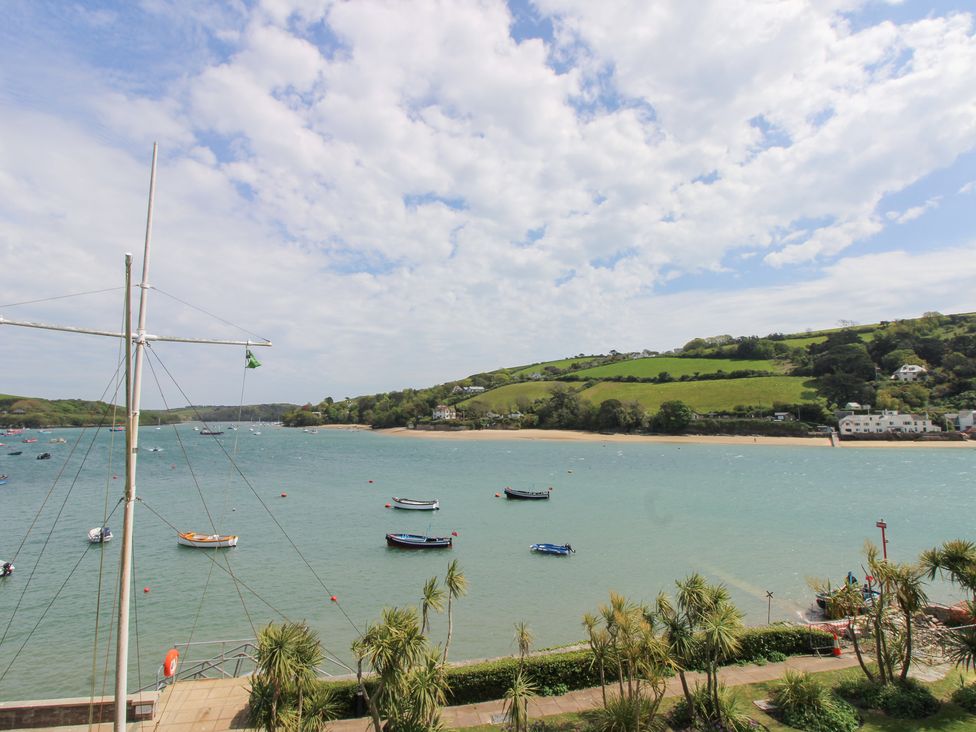 A view of boats on water with land and palm trees at 24 The Salcombe Salcombe