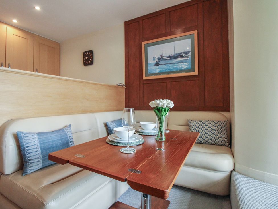 A dining room with a table set for two at 24 The Salcombe in Salcombe