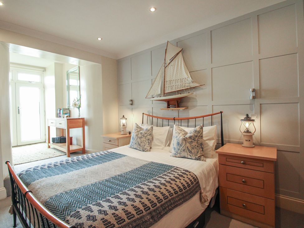 A bedroom with a bed and bedside table at 24 The Salcombe in Salcombe